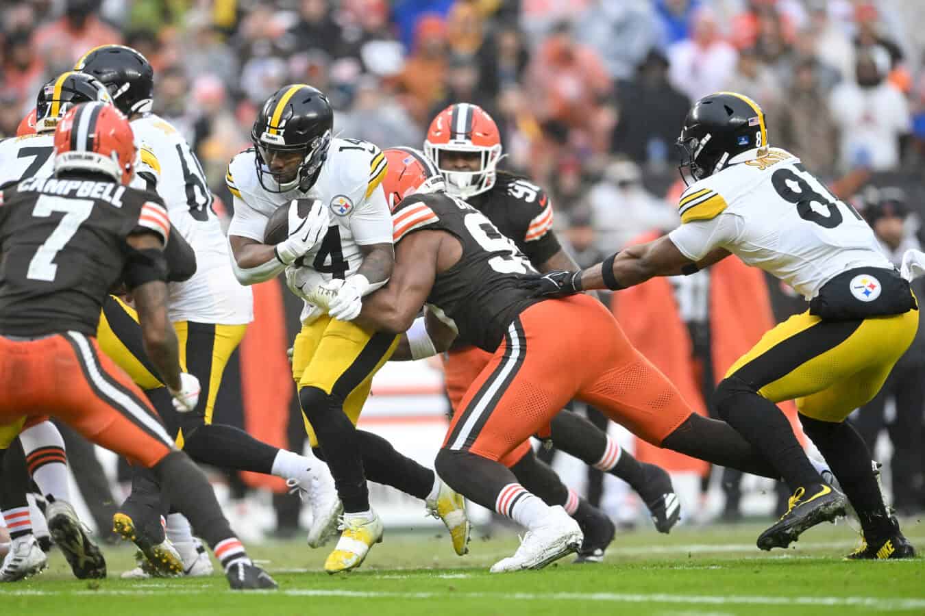 CLEVELAND, OHIO - DECEMBER 28: Kenneth Gainwell #14 of the Pittsburgh Steelers is tackled by Myles Garrett #95 of the Cleveland Browns during the first quarter of the game at Huntington Bank Field on December 28, 2025 in Cleveland, Ohio.