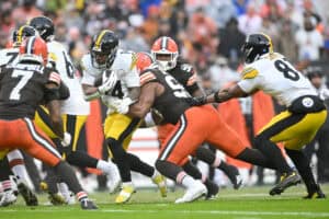 CLEVELAND, OHIO - DECEMBER 28: Kenneth Gainwell #14 of the Pittsburgh Steelers is tackled by Myles Garrett #95 of the Cleveland Browns during the first quarter of the game at Huntington Bank Field on December 28, 2025 in Cleveland, Ohio.