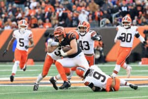 CINCINNATI, OHIO - JANUARY 04: Drew Sample #89 of the Cincinnati Bengals is tackled by Ronnie Hickman #33, Mohamoud Diabate #43 and Grant Delpit #9 of the Cleveland Browns during the third quarter of the game at Paycor Stadium on January 04, 2026 in Cincinnati, Ohio.