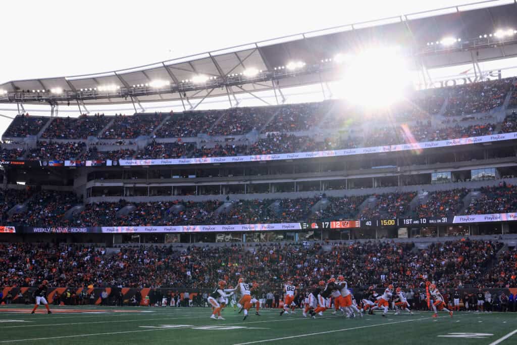 CINCINNATI, OHIO - JANUARY 04: Shedeur Sanders #12 of the Cleveland Browns hands off to teammate Dylan Sampson #22 during the fourth quarter of the game against the Cincinnati Bengals at Paycor Stadium on January 04, 2026 in Cincinnati, Ohio.