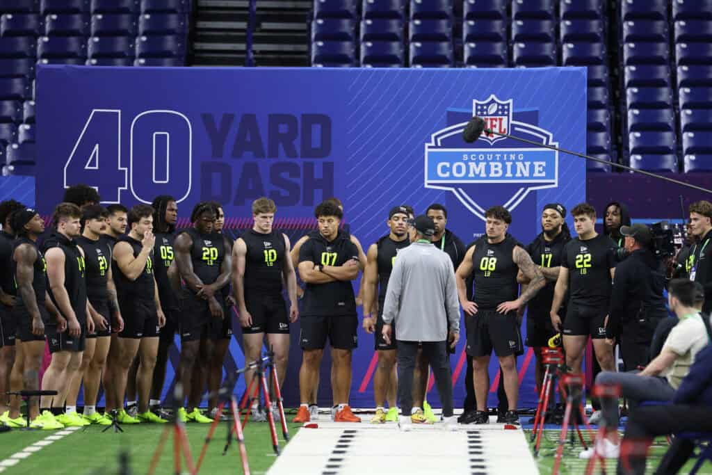 INDIANAPOLIS, INDIANA - FEBRUARY 26: Players gather at the start of the 40-yard dash during the 2026 NFL Scouting Combine at Lucas Oil Stadium on February 26, 2026 in Indianapolis, Indiana.