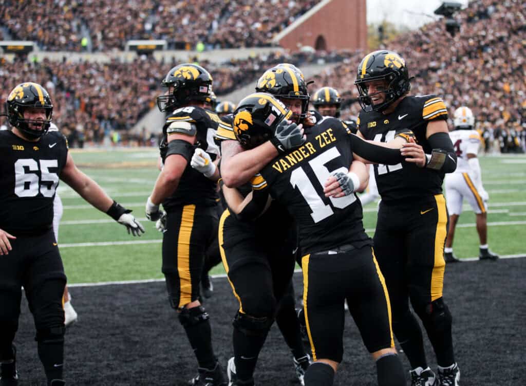 IOWA CITY, IA - OCTOBER 25: Wide receiver Reece Vander Zee #15 of the Iowa Hawkeyes is congratulated by offensive lineman Gennings Dunker #67 and quarterback Mark Gronowski #11 after a touchdown in the second half against the Minnesota Golden Gophers on October 25, 2025 at Kinnick Stadium, in Iowa City, Iowa.