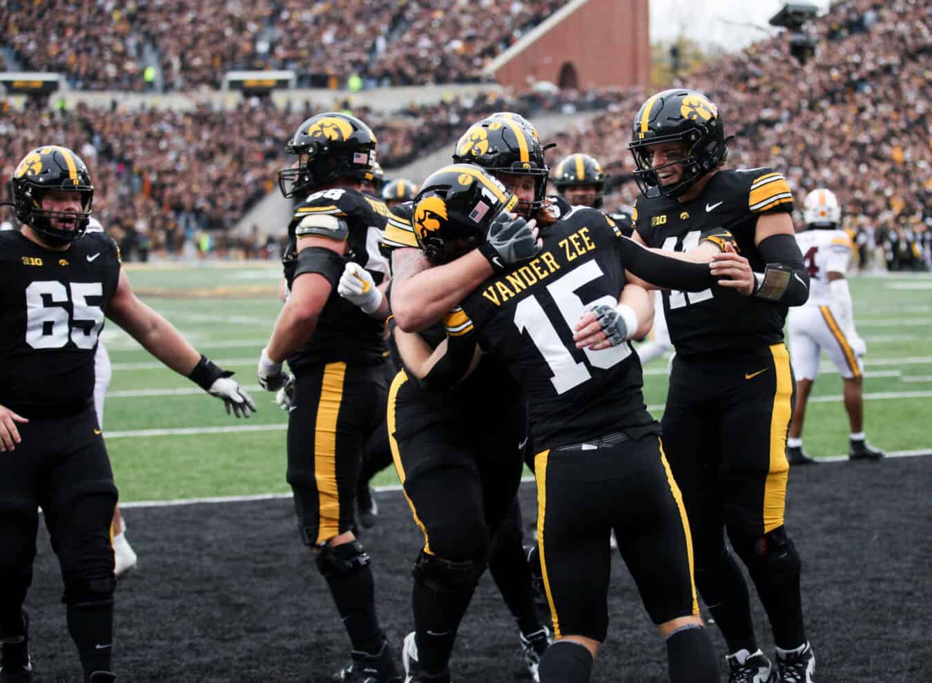 IOWA CITY, IA - OCTOBER 25: Wide receiver Reece Vander Zee #15 of the Iowa Hawkeyes is congratulated by offensive lineman Gennings Dunker #67 and quarterback Mark Gronowski #11 after a touchdown in the second half against the Minnesota Golden Gophers on October 25, 2025 at Kinnick Stadium, in Iowa City, Iowa.