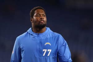 FOXBOROUGH, MASSACHUSETTS - JANUARY 11: Zion Johnson #77 of the Los Angeles Chargers looks on during warmups before the AFC Wild Card Playoff game against the New England Patriots at Gillette Stadium on January 11, 2026 in Foxborough, Massachusetts.