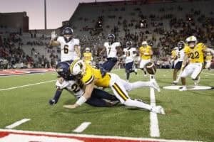 TUCSON, ARIZONA - DECEMBER 30: Quarterback Evan Svoboda #17 of the Wyoming Cowboys (C) fumbles after being hit by safety Emmanuel McNeil-Warren #22 of the Toledo Rockets during the second half of the Barstool Sports Arizona Bowl at Arizona Stadium on December 30, 2023 in Tucson, Arizona.