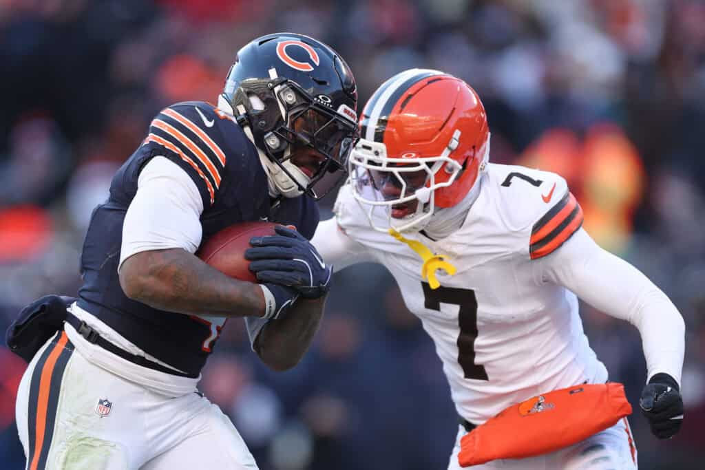 CHICAGO, ILLINOIS - DECEMBER 14: D'Andre Swift #4 of the Chicago Bears runs for a touchdown against Tyson Campbell #7 of the Cleveland Browns at Soldier Field on December 14, 2025 in Chicago, Illinois.
