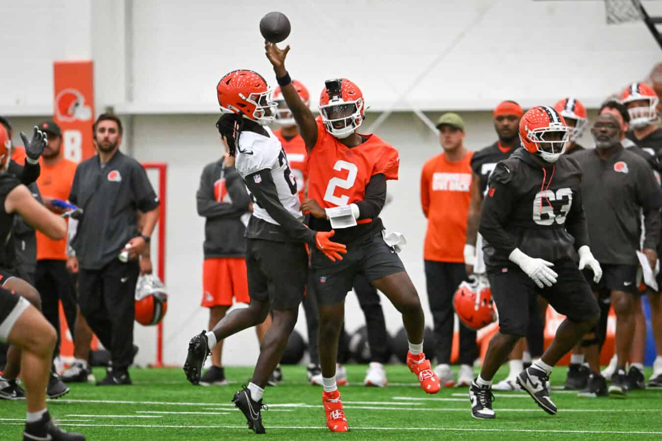 BEREA, OHIO - MAY 20: Shedeur Sanders #2 of the Cleveland Browns throws a pass as he is hit by Emmanuel McNeil-Warren #28 during the Cleveland Browns OTA Offseason Workouts at CrossCountry Mortgage Campus on May 20, 2026 in Berea, Ohio.