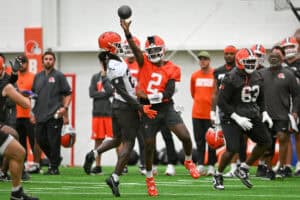 BEREA, OHIO - MAY 20: Shedeur Sanders #2 of the Cleveland Browns throws a pass as he is hit by Emmanuel McNeil-Warren #28 during the Cleveland Browns OTA Offseason Workouts at CrossCountry Mortgage Campus on May 20, 2026 in Berea, Ohio.