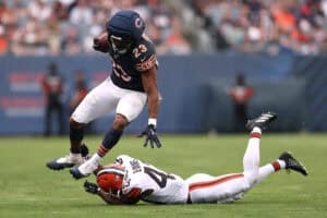 CHICAGO, ILLINOIS - AUGUST 15: Roschon Johnson #23 of the Chicago Bears breaks a tackle from Nate Evans #43 of the Cleveland Browns during the second quarter of a preseason game at Soldier Field on August 15, 2026 in Chicago, Illinois.