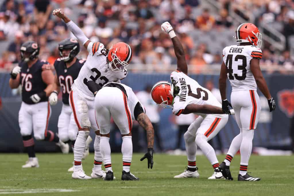 CHICAGO, ILLINOIS - AUGUST 15: Quincy Williams, Ronnie Hickman #33, and Grant Delpit #9 of the Cleveland Browns celebrate during the first quarter of a preseason game against the Chicago Bears at Soldier Field on August 15, 2026 in Chicago, Illinois.