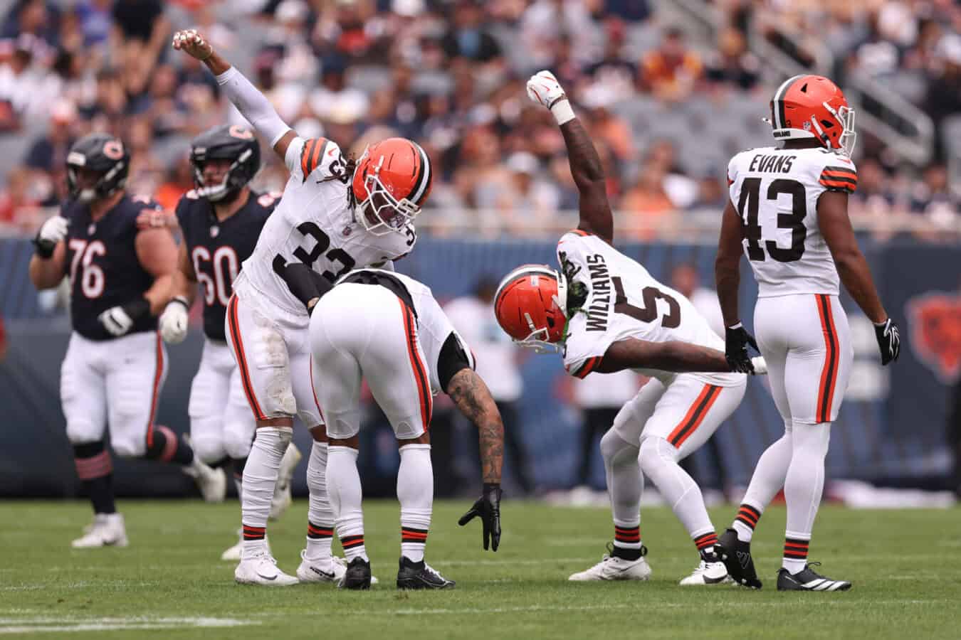 CHICAGO, ILLINOIS - AUGUST 15: Quincy Williams, Ronnie Hickman #33, and Grant Delpit #9 of the Cleveland Browns celebrate during the first quarter of a preseason game against the Chicago Bears at Soldier Field on August 15, 2026 in Chicago, Illinois.