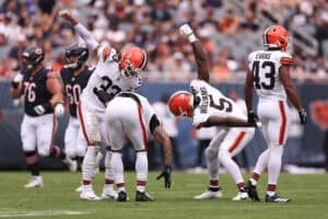 CHICAGO, ILLINOIS - AUGUST 15: Quincy Williams, Ronnie Hickman #33, and Grant Delpit #9 of the Cleveland Browns celebrate during the first quarter of a preseason game against the Chicago Bears at Soldier Field on August 15, 2026 in Chicago, Illinois.