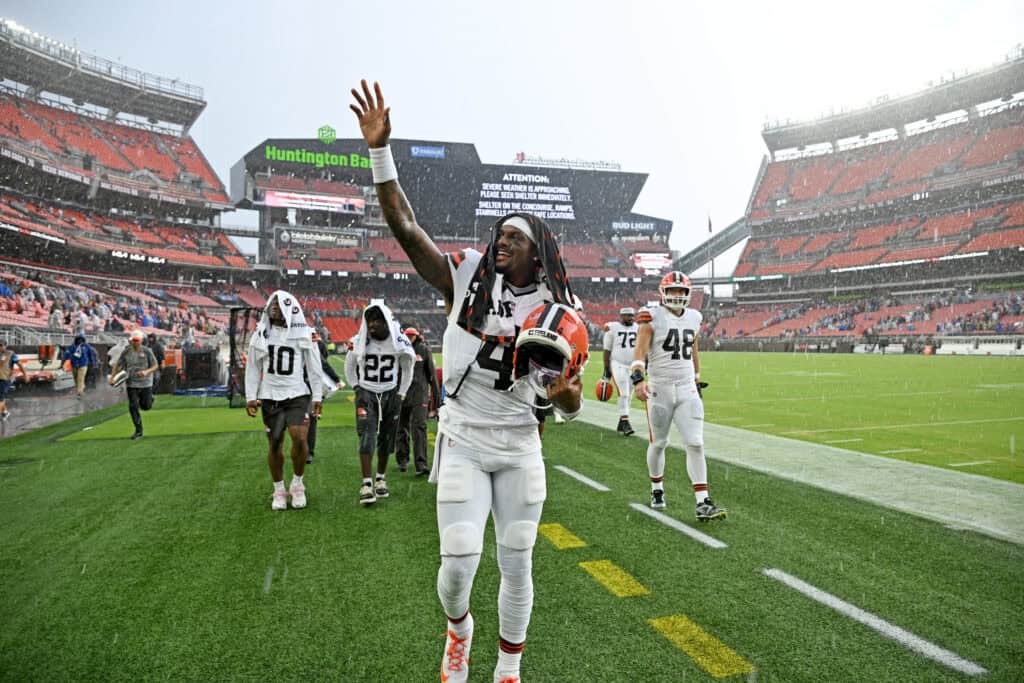 CLEVELAND, OHIO - AUGUST 22: Quarterback Deshaun Watson #4 of the Cleveland Browns waves to the fans as he leaves the field for a weather delay during the first quarter of a preseason game against the Buffalo Bills at Huntington Bank Field on August 22, 2026 in Cleveland, Ohio.