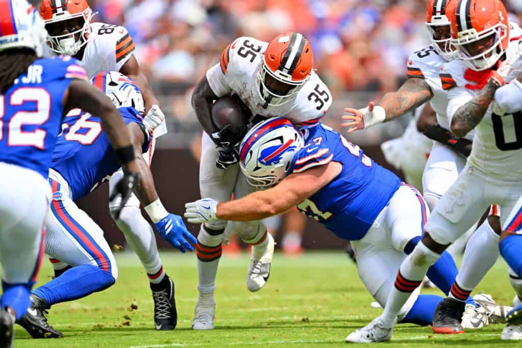 CLEVELAND, OHIO - AUGUST 22: Running back Raheim Sanders #35 of the Cleveland Browns is tackled by Greg Gaines #97 of the Buffalo Bills during the second quarter of the preseason game at Huntington Bank Field on August 22, 2026, in Cleveland, Ohio.