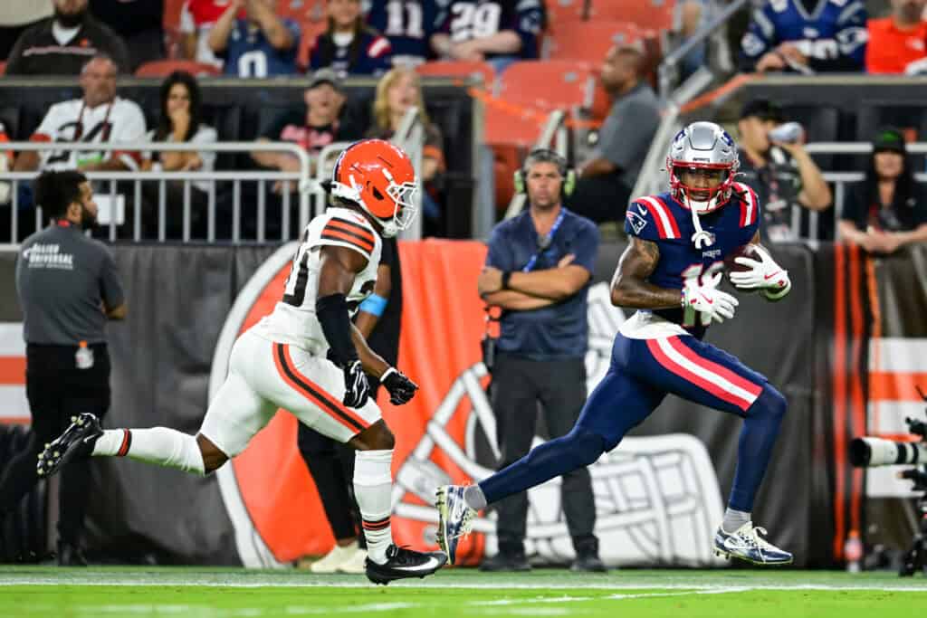 CLEVELAND, OHIO - AUGUST 27: Kyle Williams #18 of the New England Patriots scores a 45-yard touchdown against D'Angelo Ross #20 of the Cleveland Browns during the first quarter of a preseason game at Huntington Bank Field on August 27, 2026 in Cleveland, Ohio.