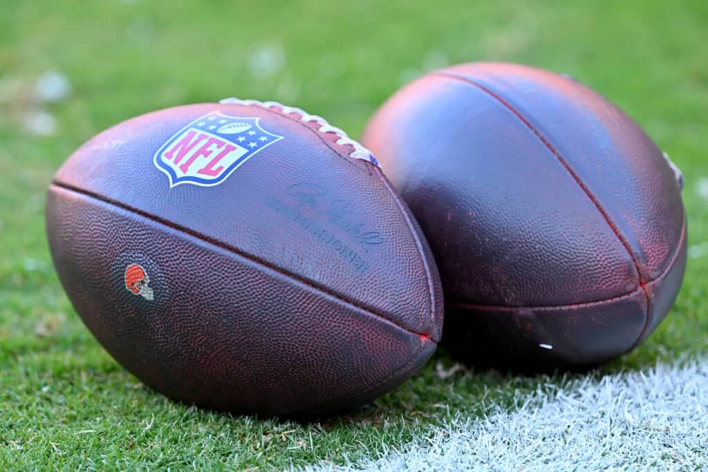 CLEVELAND, OHIO - AUGUST 27: Two official NFL footballs sit on the field before a preseason game between the Cleveland Browns and the New England Patriots at Huntington Bank Field on August 27, 2026 in Cleveland, Ohio.