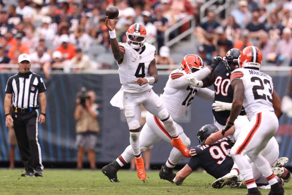CHICAGO, ILLINOIS - AUGUST 15: Deshaun Watson #4 of the Cleveland Browns scrambles out of the pocket and throws downfield during the second quarter of a preseason game against the Chicago Bears at Soldier Field on August 15, 2026 in Chicago, Illinois.