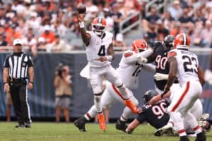 CHICAGO, ILLINOIS - AUGUST 15: Deshaun Watson #4 of the Cleveland Browns scrambles out of the pocket and throws downfield during the second quarter of a preseason game against the Chicago Bears at Soldier Field on August 15, 2026 in Chicago, Illinois.