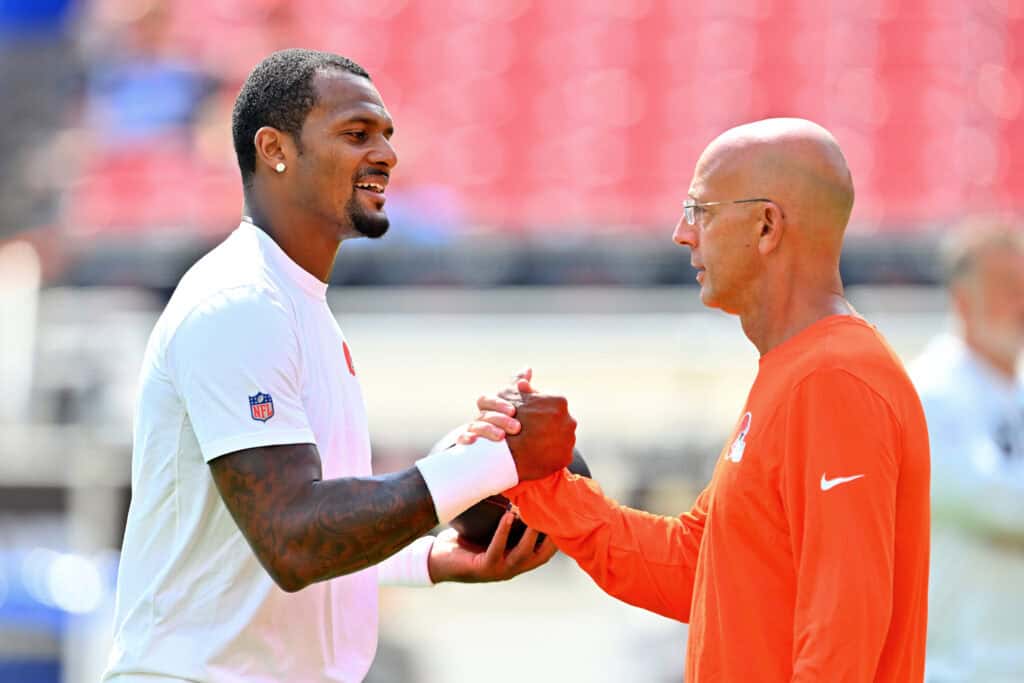 CLEVELAND, OHIO - AUGUST 22: Quarterback Deshaun Watson #4 greets quarterbacks coach Mike Bajakian before a preseason game against the Buffalo Bills at Huntington Bank Field on August 22, 2026 in Cleveland, Ohio.