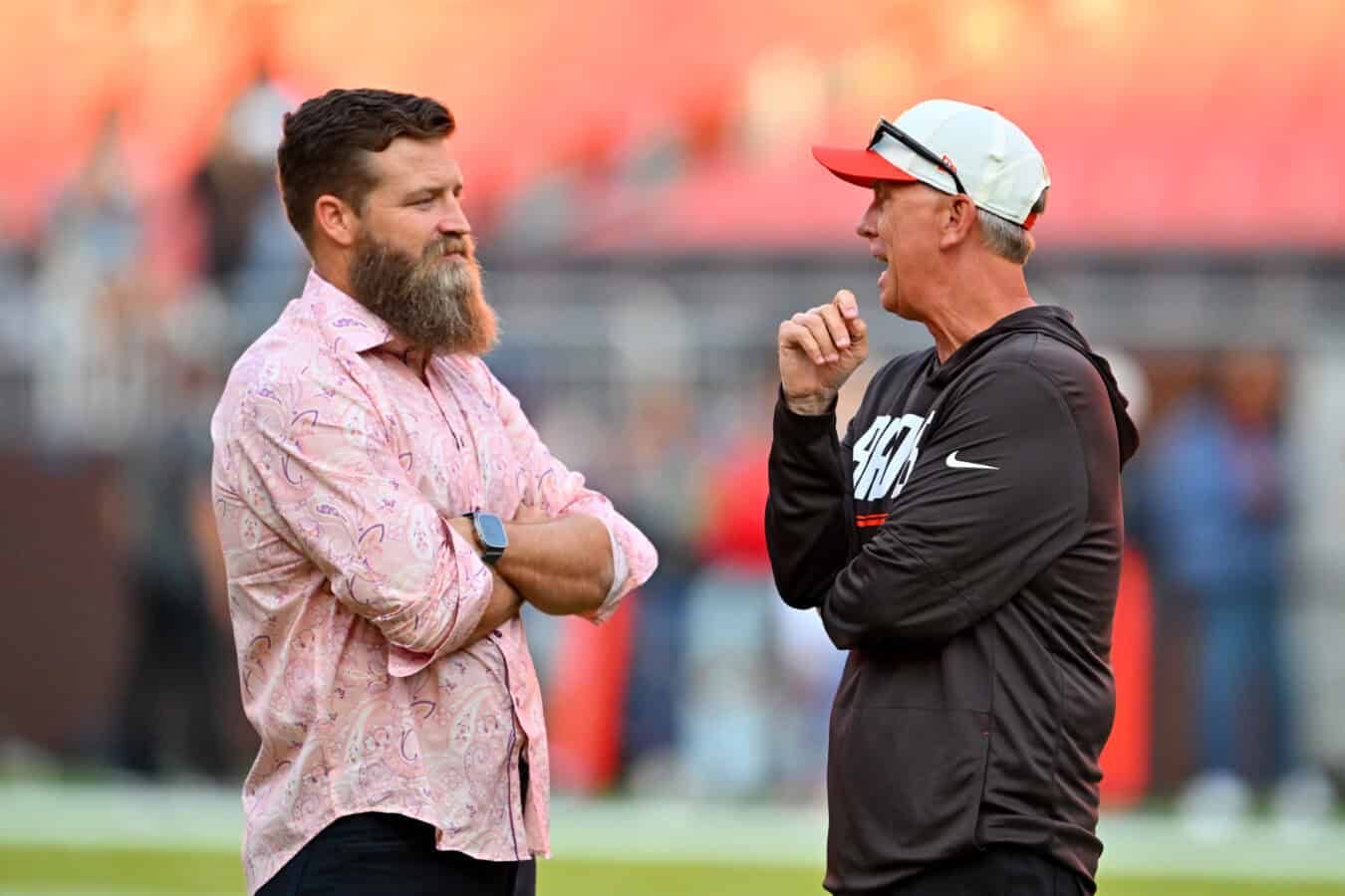 CLEVELAND, OHIO - AUGUST 27: Thursday Night Football analyst Ryan Fitzpatrick talks with head coach Todd Monken of the Cleveland Browns before a preseason game against the New England Patriots at Huntington Bank Field on August 27, 2026 in Cleveland, Ohio.