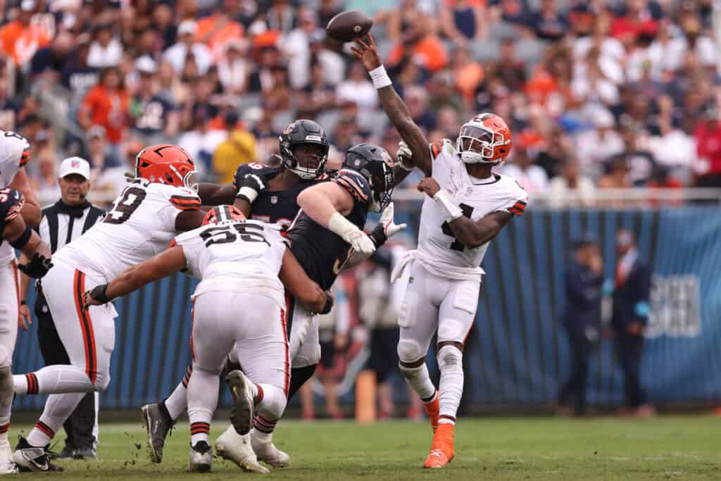 CHICAGO, ILLINOIS - AUGUST 15: Deshaun Watson #4 of the Cleveland Browns scrambles out of the pocket and throws downfield during the second quarter of a preseason game against the Chicago Bears at Soldier Field on August 15, 2026 in Chicago, Illinois.