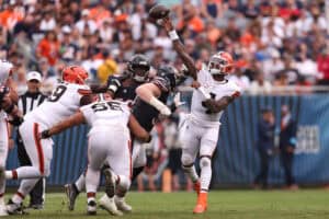 CHICAGO, ILLINOIS - AUGUST 15: Deshaun Watson #4 of the Cleveland Browns scrambles out of the pocket and throws downfield during the second quarter of a preseason game against the Chicago Bears at Soldier Field on August 15, 2026 in Chicago, Illinois.