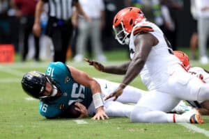 JACKSONVILLE, FLORIDA - SEPTEMBER 13: Mason Graham #94 of the Cleveland Browns sacks Trevor Lawrence #16 of the Jacksonville Jaguars during the third quarter of the game at EverBank Stadium on September 13, 2026 in Jacksonville, Florida.