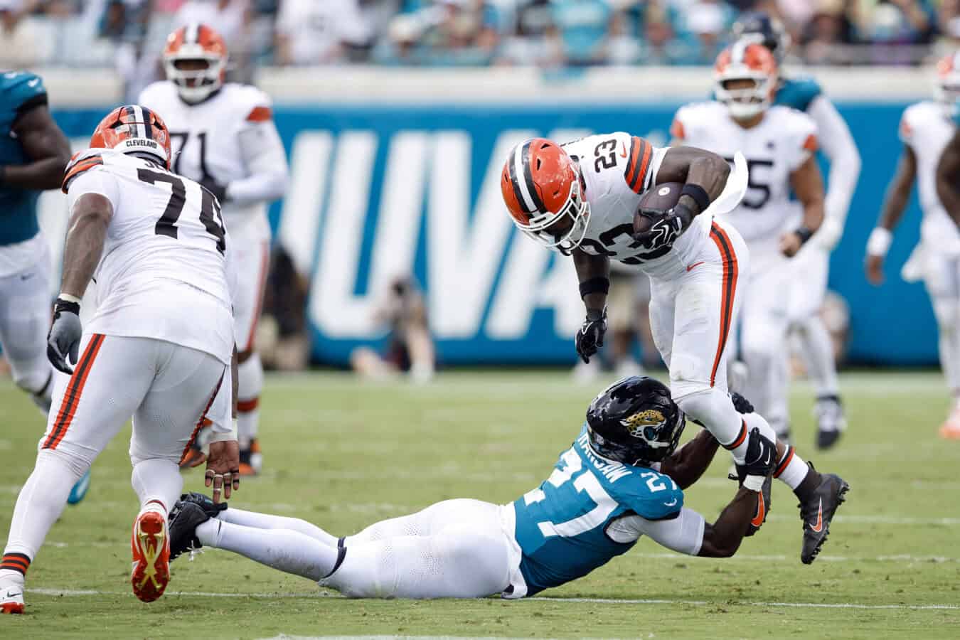 JACKSONVILLE, FLORIDA - SEPTEMBER 13: Raheim Sanders #23 of the Cleveland Browns is tackled by Caleb Ransaw #27 of the Jacksonville Jaguars during the first half of the game at EverBank Stadium on September 13, 2026 in Jacksonville, Florida.