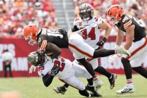 TAMPA, FLORIDA - SEPTEMBER 20: Tykee Smith #23 of the Tampa Bay Buccaneers is tackled by Quinshon Judkins #10 of the Cleveland Browns during the first quarter of the game at Raymond James Stadium on September 20, 2026 in Tampa, Florida.