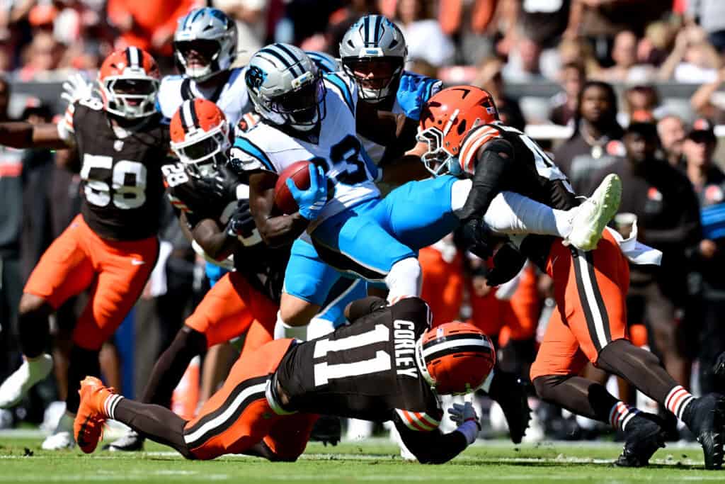 CLEVELAND, OHIO - SEPTEMBER 27: David Moore #83 of the Carolina Panthers is tackled by Malachi Corley #11 and Easton Mascarenas-Arnold #42 of the Cleveland Browns during the first quarter at Huntington Bank Field on September 27, 2026 in Cleveland, Ohio.