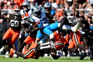 CLEVELAND, OHIO - SEPTEMBER 27: David Moore #83 of the Carolina Panthers is tackled by Malachi Corley #11 and Easton Mascarenas-Arnold #42 of the Cleveland Browns during the first quarter at Huntington Bank Field on September 27, 2026 in Cleveland, Ohio.