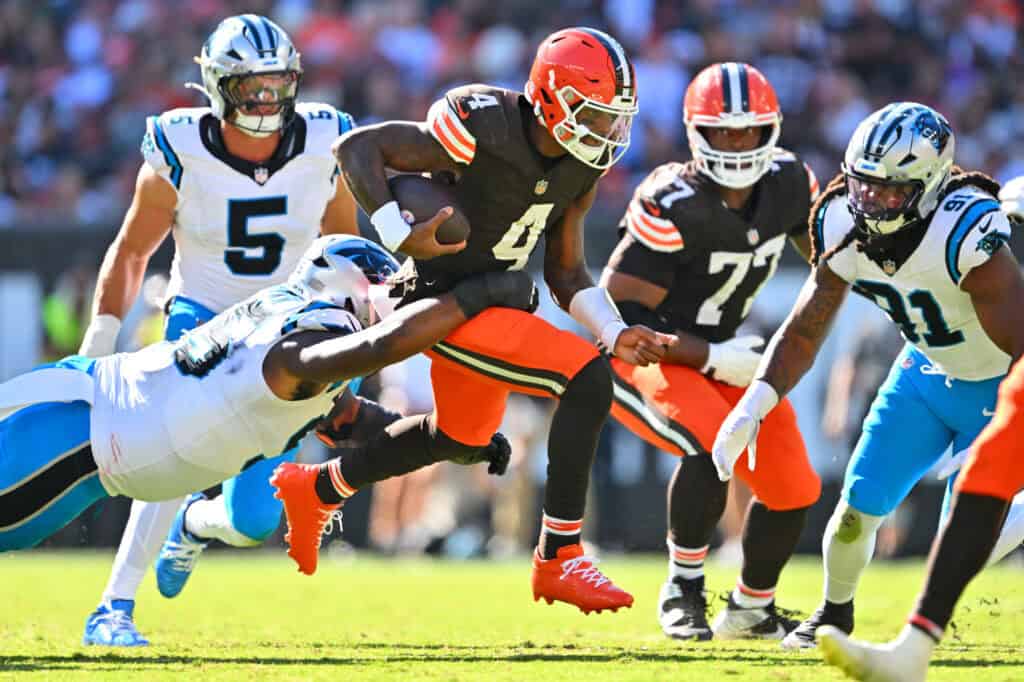 CLEVELAND, OHIO - SEPTEMBER 27: Deshaun Watson #4 of the Cleveland Browns runs the ball against Derrick Brown #95 of the Carolina Panthers during the fourth quarter at Huntington Bank Field on September 27, 2026 in Cleveland, Ohio.