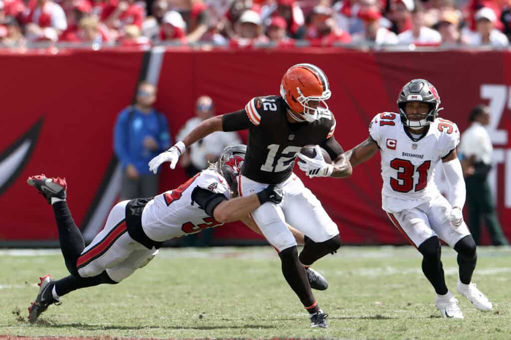 TAMPA, FLORIDA - SEPTEMBER 20: Denzel Boston #12 of the Cleveland Browns catches the ball against Alex Anzalone #34 of the Tampa Bay Buccaneers during the third quarter of the game at Raymond James Stadium on September 20, 2026 in Tampa, Florida.