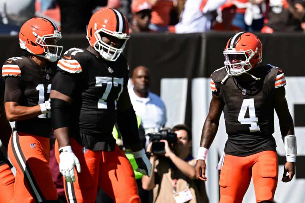 CLEVELAND, OHIO - SEPTEMBER 27: Deshaun Watson #4 of the Cleveland Browns is congratulated by Zion Johnson #77 and Denzel Boston #12 after throwing a pass for a touchdown against the Carolina Panthers during the second quarter at Huntington Bank Field on September 27, 2026 in Cleveland, Ohio.