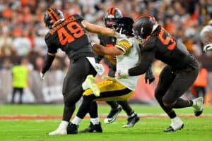 CLEVELAND, OHIO - OCTOBER 01: Carsen Ryan #48 and Isaiah McGuire #57 of the Cleveland Browns sack Aaron Rodgers #8 of the Pittsburgh Steelers during the second quarter of the game at Huntington Bank Field on October 01, 2026 in Cleveland, Ohio.