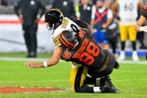 CLEVELAND, OHIO - OCTOBER 01: Quarterback Aaron Rodgers #8 of the Pittsburgh Steelers is sacked by defensive end Adin Huntington #98 of the Cleveland Browns during the third quarter at Huntington Bank Field on October 01, 2026 in Cleveland, Ohio.