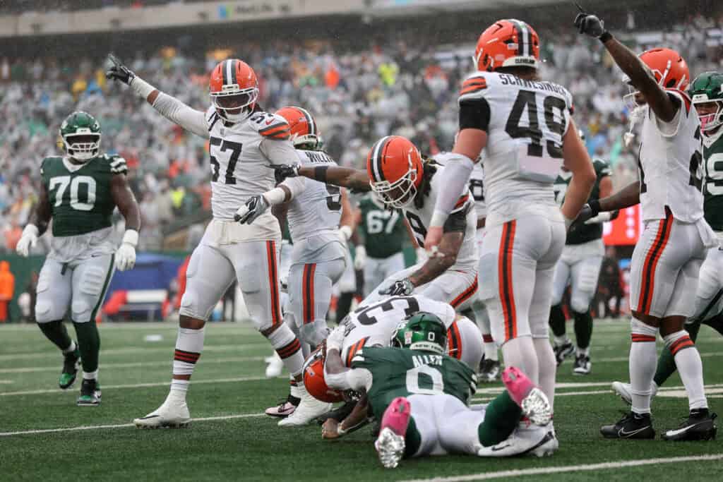 EAST RUTHERFORD, NEW JERSEY - OCTOBER 11: Ronnie Hickman #33 of the Cleveland Browns recovers a fumble against Braelon Allen #0 of the New York Jets during the third quarter of the game at MetLife Stadium on October 11, 2026 in East Rutherford, New Jersey.