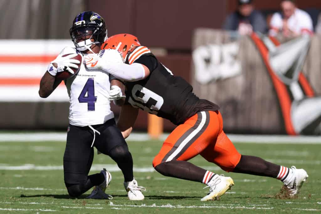 CLEVELAND, OHIO - OCTOBER 18: Carson Schwesinger #49 of the Cleveland Browns tackles Zay Flowers #4 of the Baltimore Ravens during the second quarter of the game at Huntington Bank Field on October 18, 2026 in Cleveland, Ohio