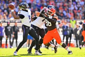 CLEVELAND, OHIO - OCTOBER 18: Tyler Huntley #5 of the Baltimore Ravens throws a pass against Adin Huntington #98 of the Cleveland Browns during the second quarter of the game at Huntington Bank Field on October 18, 2026 in Cleveland, Ohio.