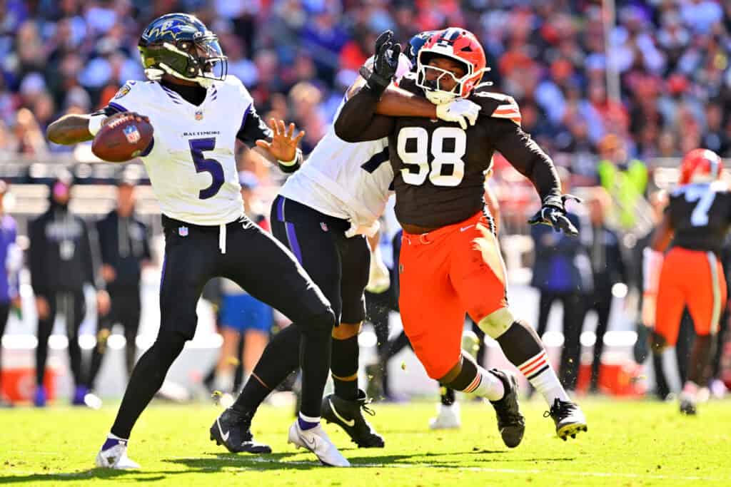 CLEVELAND, OHIO - OCTOBER 18: Tyler Huntley #5 of the Baltimore Ravens looks to pass against Adin Huntington #98 of the Cleveland Browns during the second quarter of the game at Huntington Bank Field on October 18, 2026 in Cleveland, Ohio.