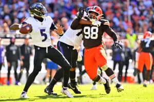 CLEVELAND, OHIO - OCTOBER 18: Tyler Huntley #5 of the Baltimore Ravens looks to pass against Adin Huntington #98 of the Cleveland Browns during the second quarter of the game at Huntington Bank Field on October 18, 2026 in Cleveland, Ohio.