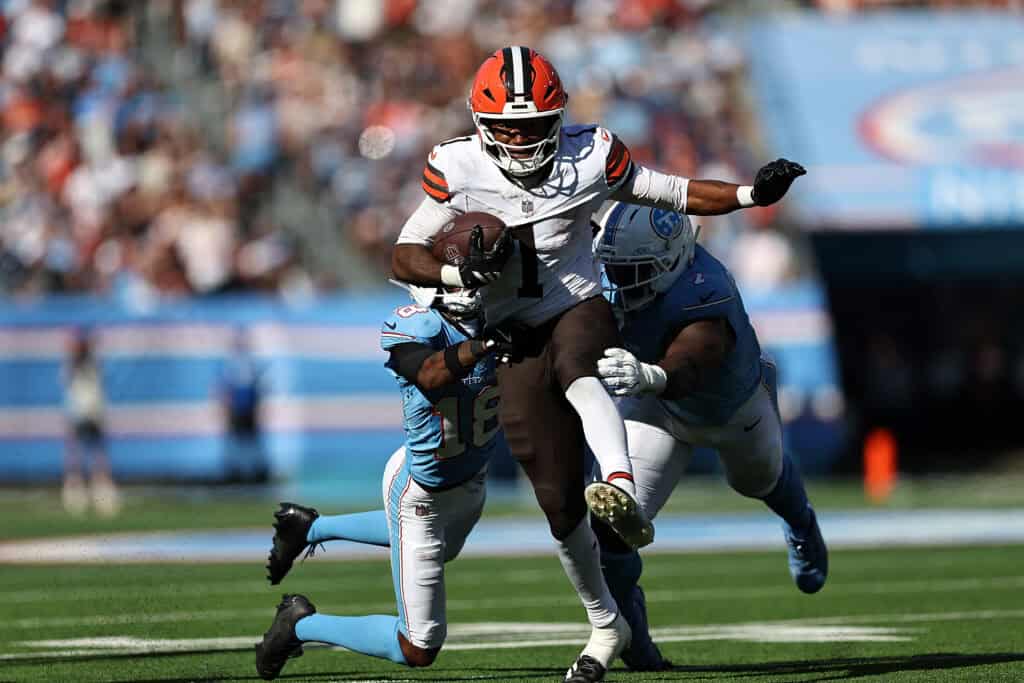NASHVILLE, TENNESSEE - OCTOBER 25: Kc Concepcion #1 of the Cleveland Browns carries the ball against Cor'dale Flott #18 of the Tennessee Titans and Oluwafemi Oladejo #7 of the Tennessee Titans during the second half at Nissan Stadium on October 25, 2026 in Nashville, Tennessee.