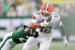 EAST RUTHERFORD, NEW JERSEY - OCTOBER 11: Denzel Boston #12 of the Cleveland Browns rushes for yards against Brandon Stephens #21 of the New York Jets during the first quarter of the game at MetLife Stadium on October 11, 2026 in East Rutherford, New Jersey.